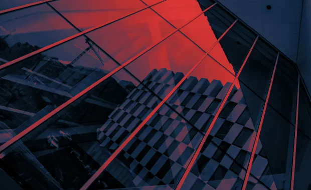 Close up of glass building reflecting red sky