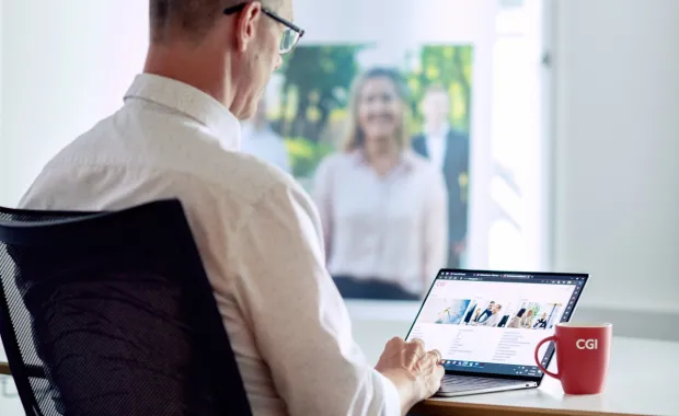 Post-quantum cryptography consultant looks at CGI website on laptop