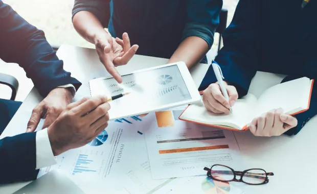 professionals having a meeting looking over some reference materials