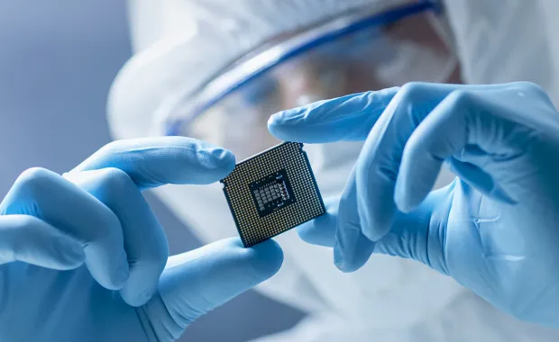 Researcher looks at technology microchip in a lab