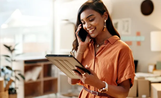 Retail employee reads marketing campaign on tablet, powered by agentic AI