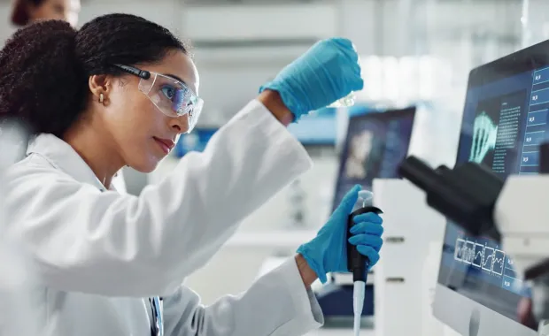 Female scientist working with a vial in a laboratory