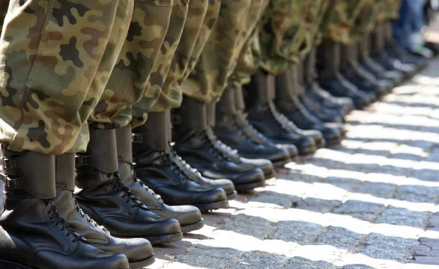 a line of soldiers shown from calves down