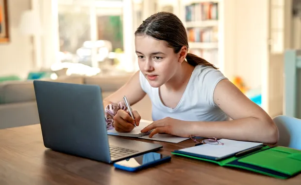 Girl working on laptop at desk