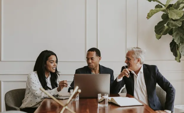 three consultants meeting at conference table