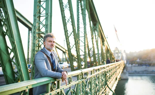 man waiting on a bridge