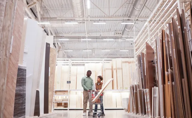 Wide angle of African American father and son shopping in hardware store