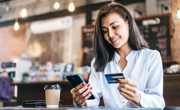 woman credit card smartphone coffee shop