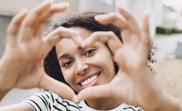 woman making heart symbol with her hands
