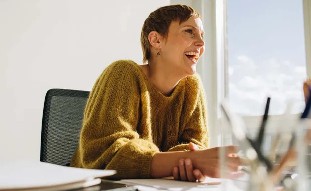 woman smiling looking at computer