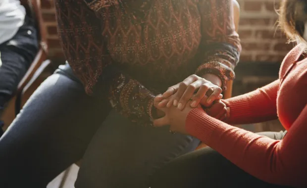 Women supporting each other holding hands