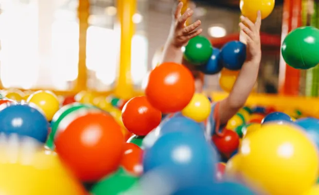 child playing in ball pit
