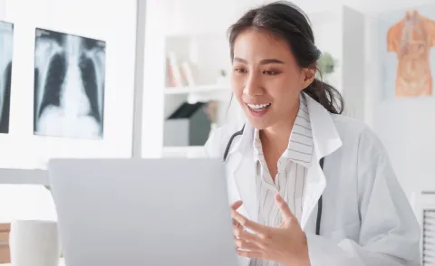 healthcare professional looking at xray on laptop