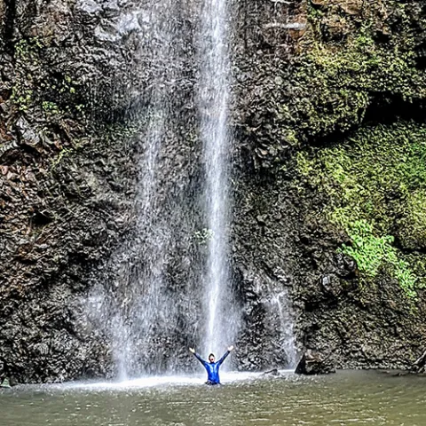 Marcus Obusan under a waterfall