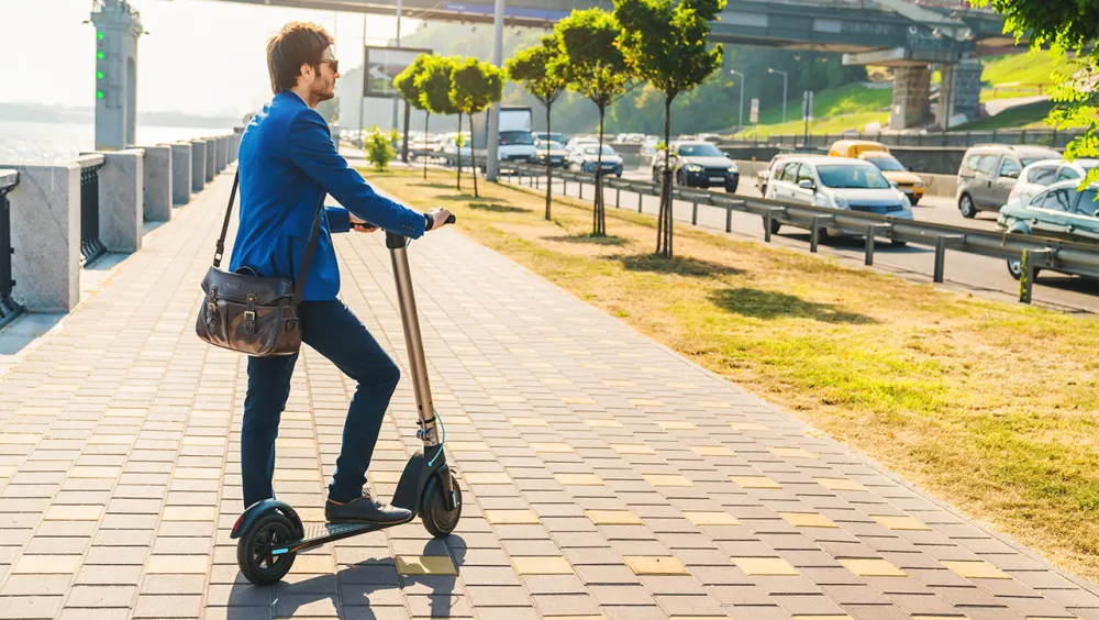 Young man on e-scooter in a modern city Young man on e-scooter in a modern city
