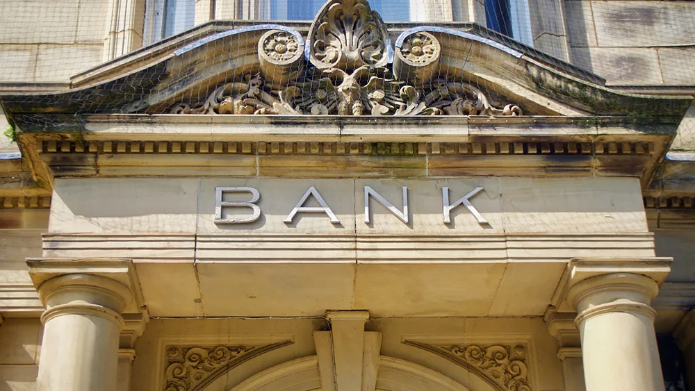 Front of an old, imposing bank building 