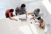 Aerial view of colleagues meeting around a conference table