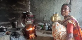 Rural woman cooking in a stove