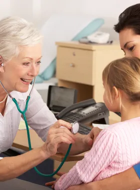 doctor uses stethoscope to listen to heartbeat of small child