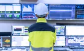 manufacturing worker looking at the monitor screens