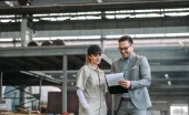 Manager and employee talking at manufacturing factory