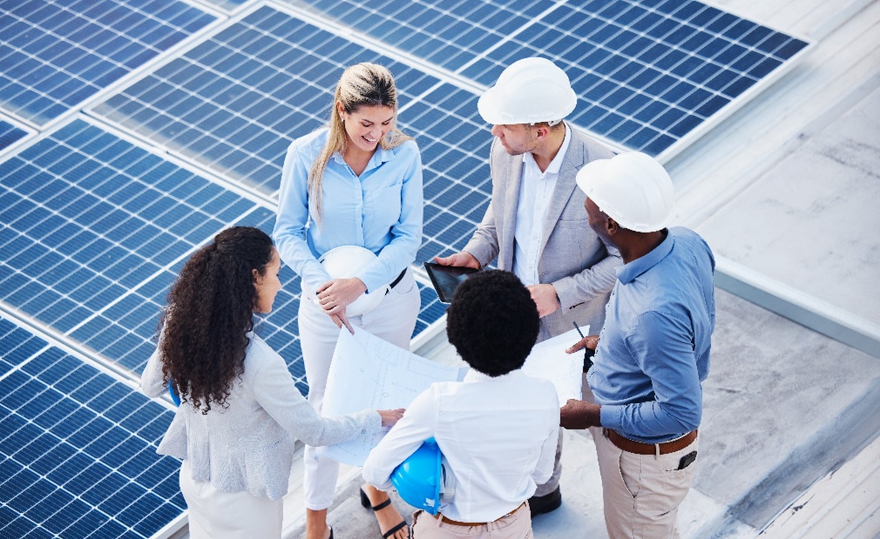 Sustainability consultants stood by solar panels
