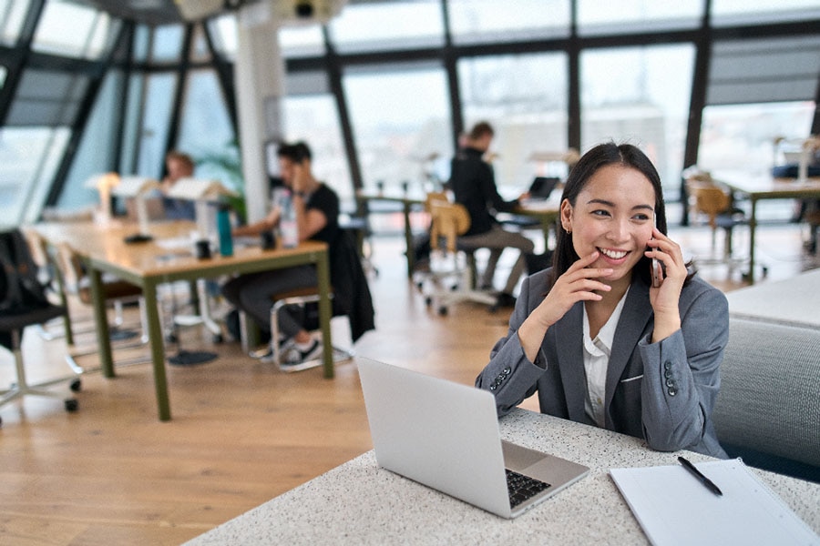 A happy young woman working in an office 