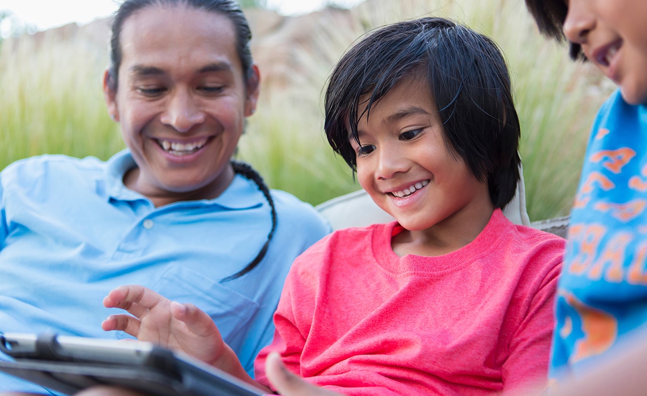 three native american children outdoors