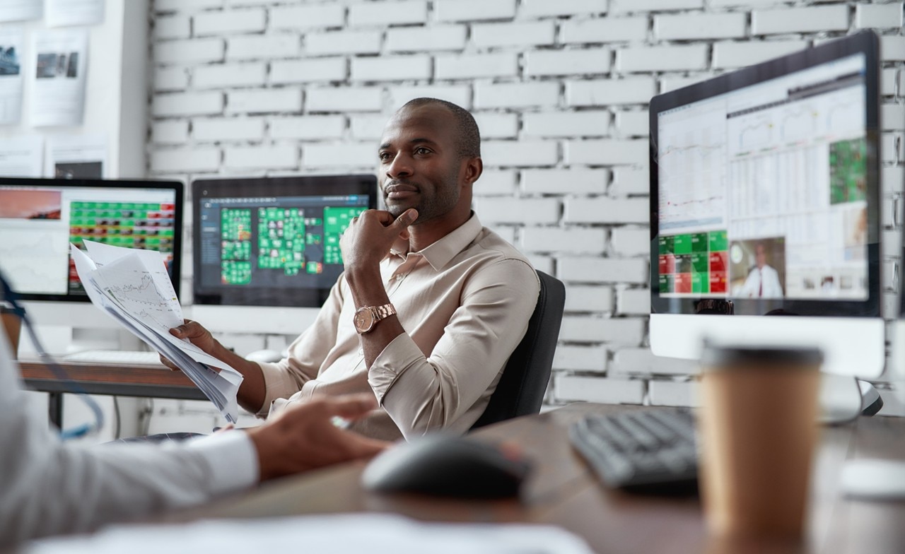 Two trade colleagues discussing ideas in a tech office setting