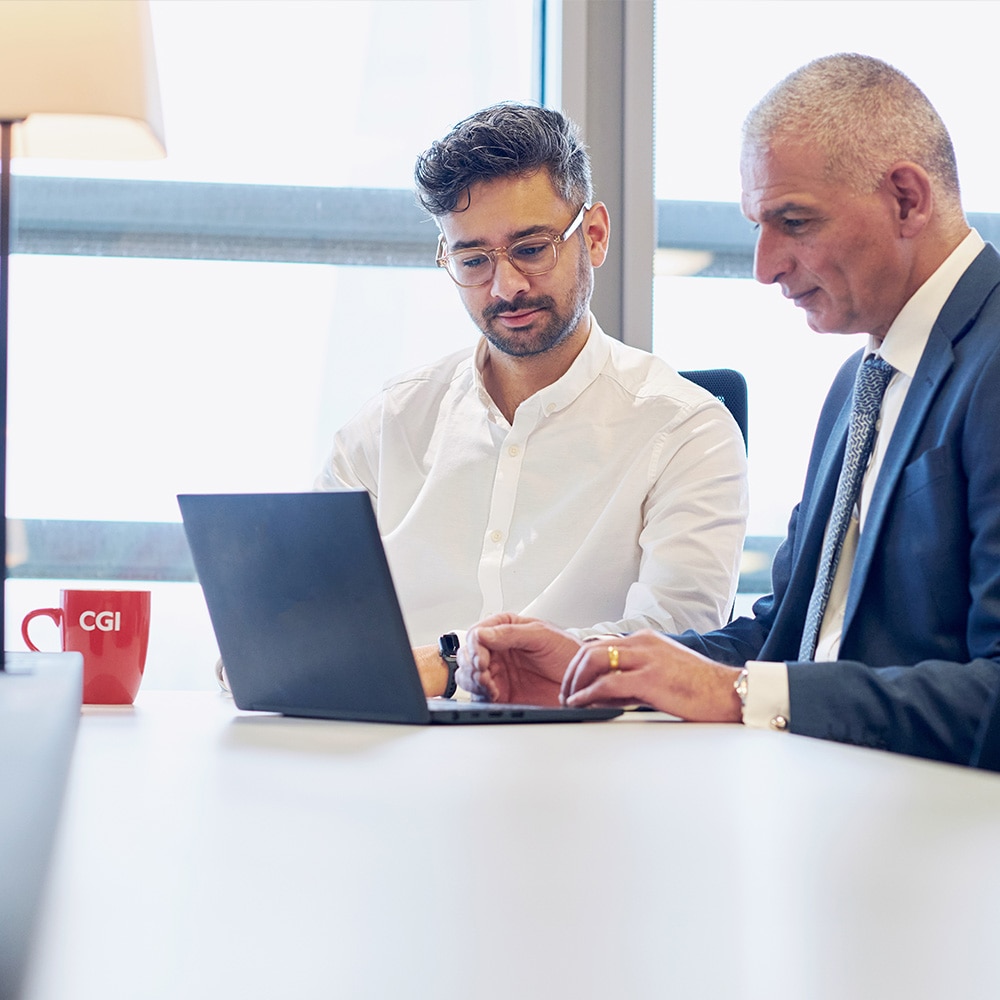 Two CGI consultants working on a project