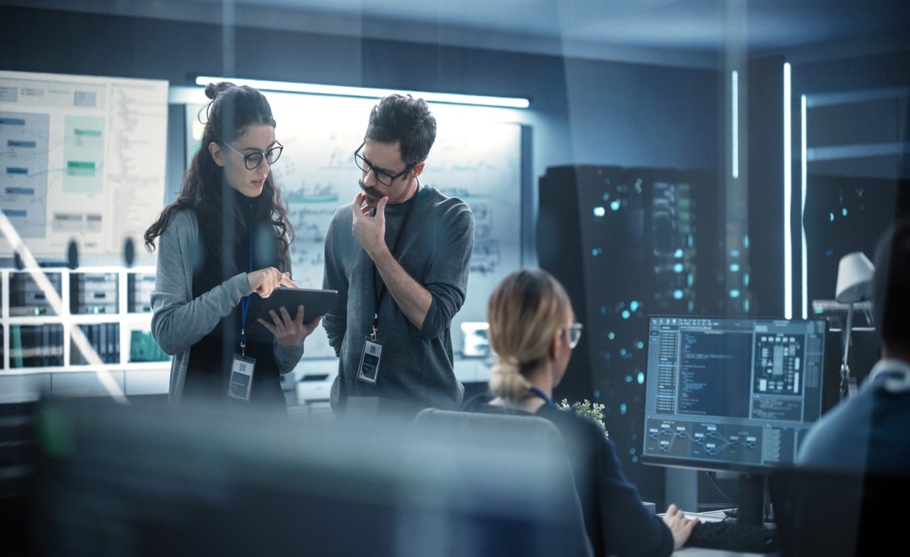 Two-creative-young-engineers-using-tablet-computer-to-analyze-and-discuss-598538551 Zwei Ingenieure analysieren und diskutieren auf einem Tablet im Rahmen der Entwicklung von Augmented Reality Anwendungen im Automotive-Bereich und prototypischer Umsetzung von AR im Fahrzeugkontext