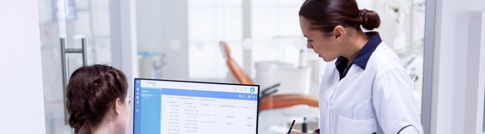 two-medical-professionals-reviewing-data-monitor-392194268-mobile Two medical professionals reviewing health data on a monitor