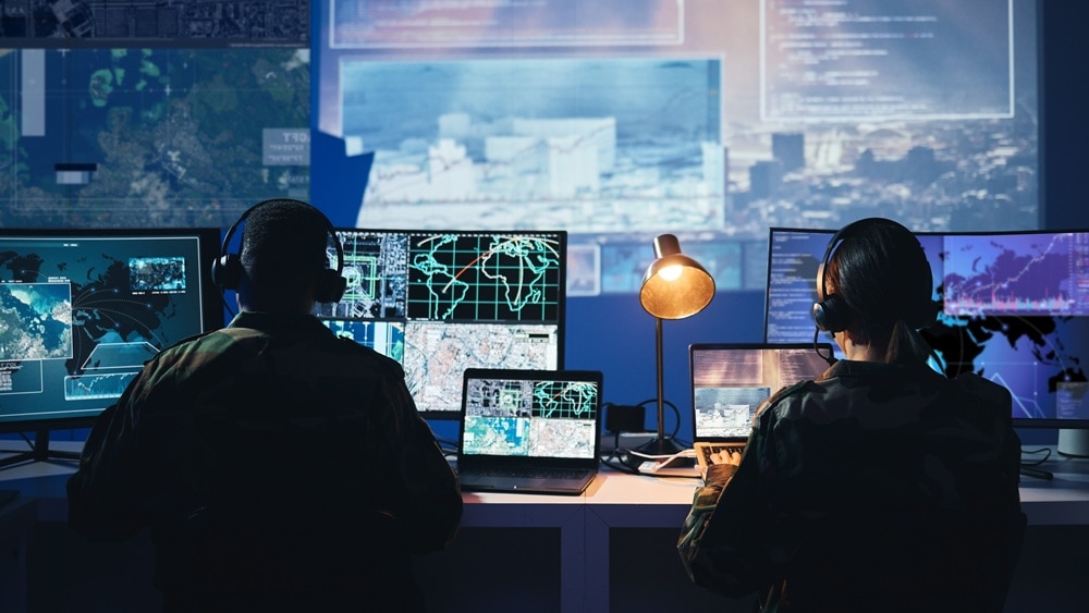 two-military-computer-specialists-working-control-room-646850645-medium Two military computer specialists working in a control room