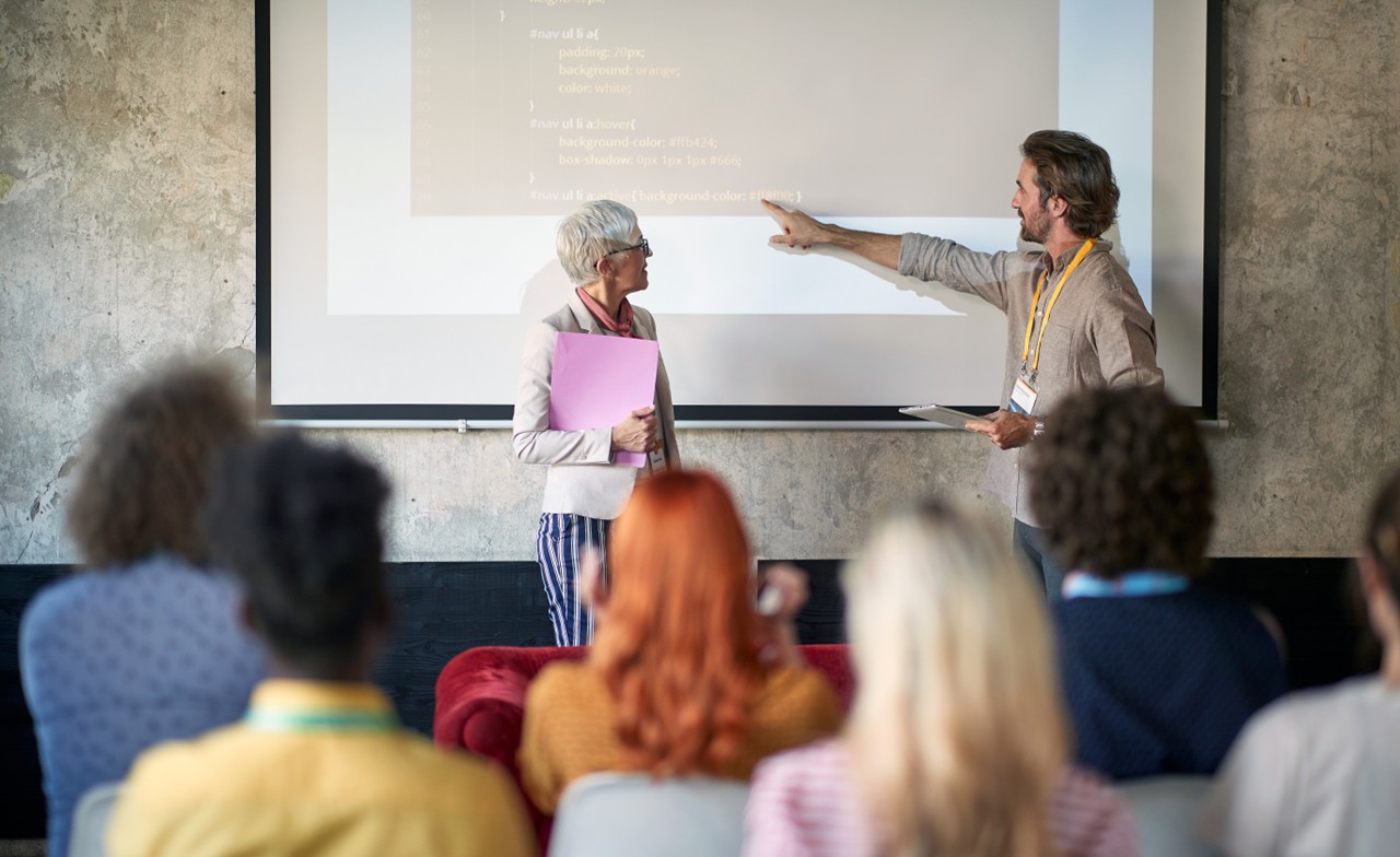 Two people presenting at an event