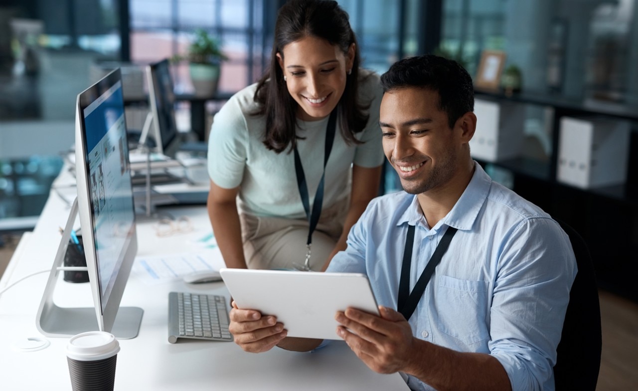 two-smiling-businesspeople-looking-at-tablet Two smiling business people looking at a tablet