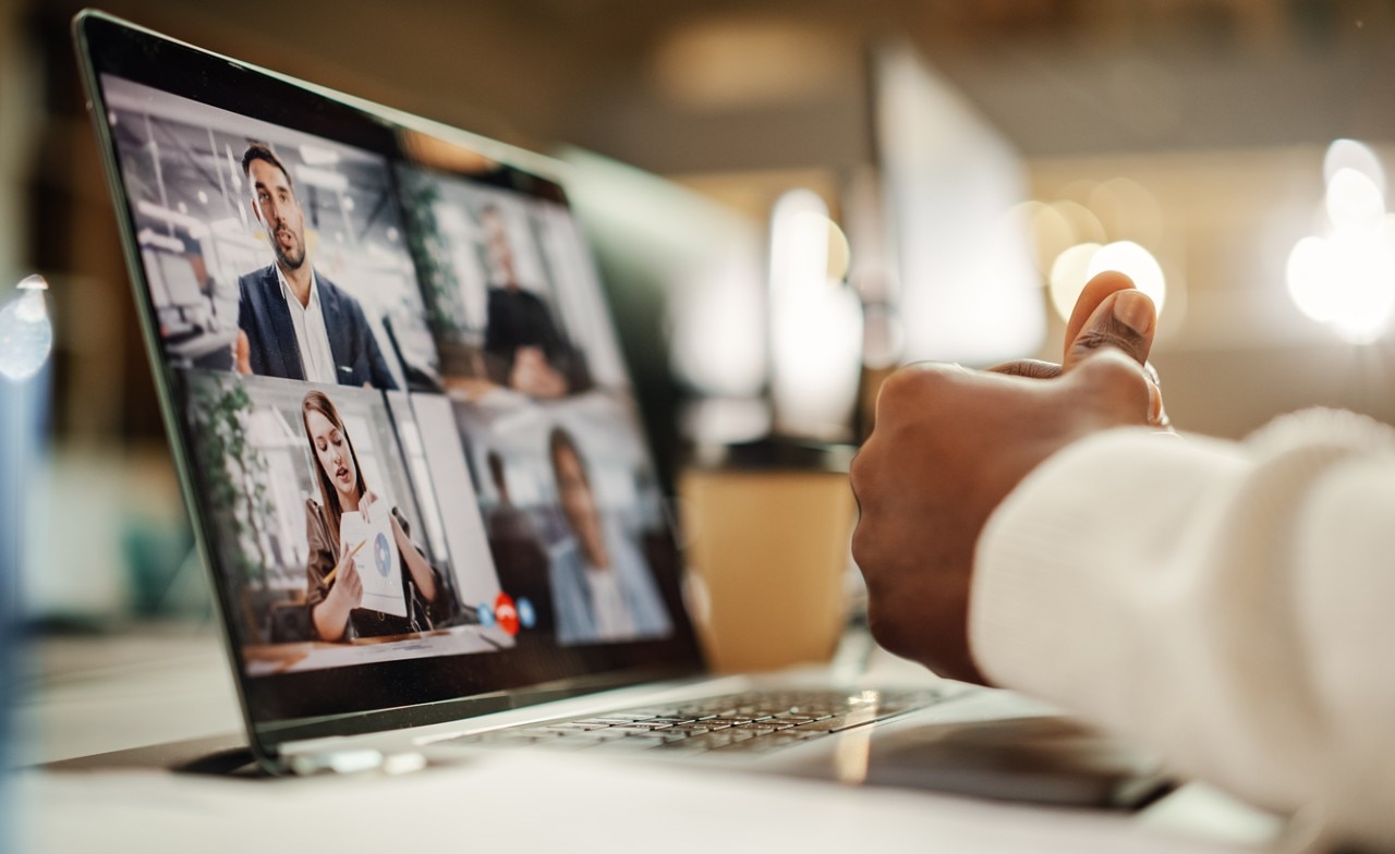 A person participating in a virtual meeting on a computer screen