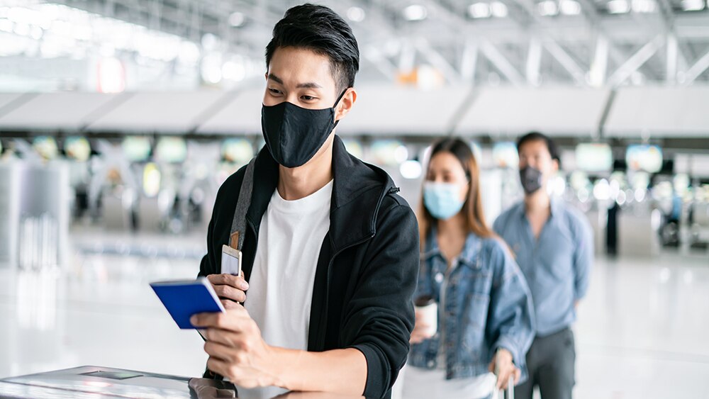 visa passport travel  man at an airport counter holding his visa/passport