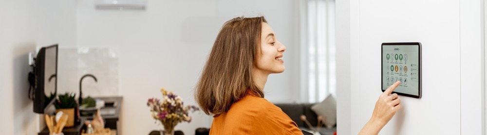 Woman interacting with smart meter Woman interacting with smart meter