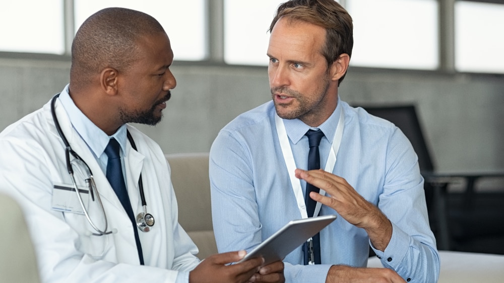 clinicians a talking in a hospital setting