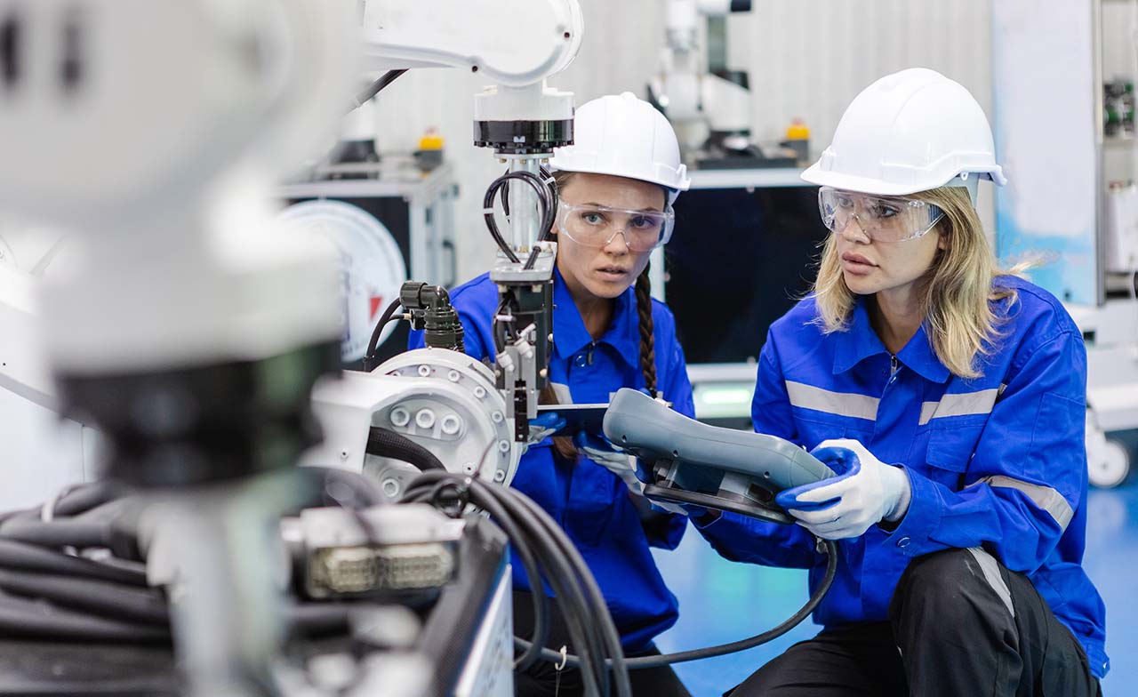 Engineers using remote automation robotics digital factory Engineers using remote automation robotics digital factory