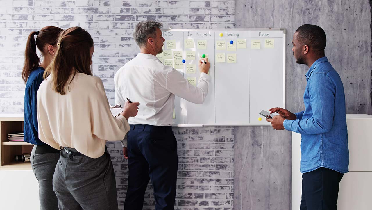 team members writing on a whiteboard