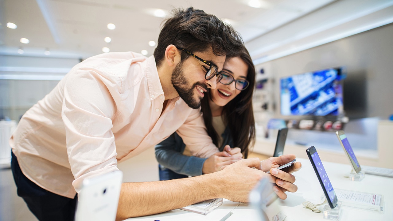 people-trying-mobile-phone-in-store-medium people trying mobile phone in store