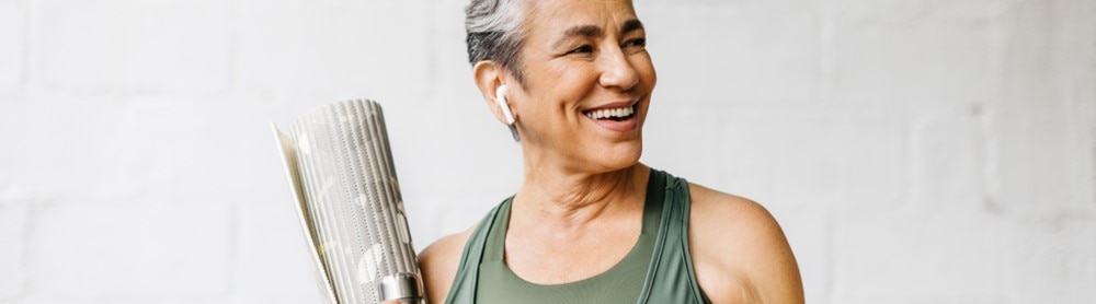 Femme avec un tapis de yoga Femme avec un tapis de yoga
