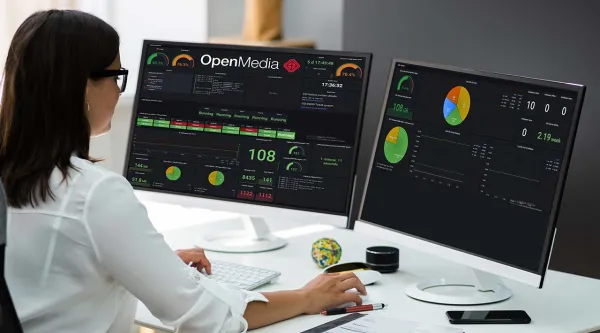 administrator analyzing OpenMedia metrics on monitor