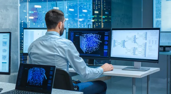 computer engineer creating neural network at workstation