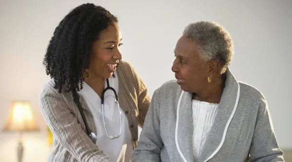 Doctor helping patient in a health care setting