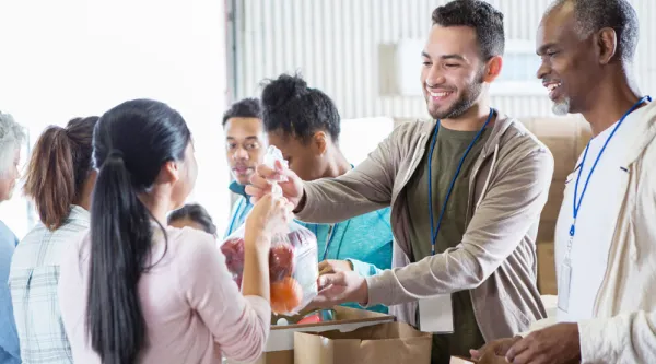 volunteers offering food baskets