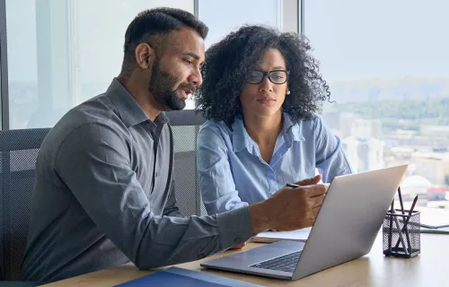 Bankers pointing at a laptop