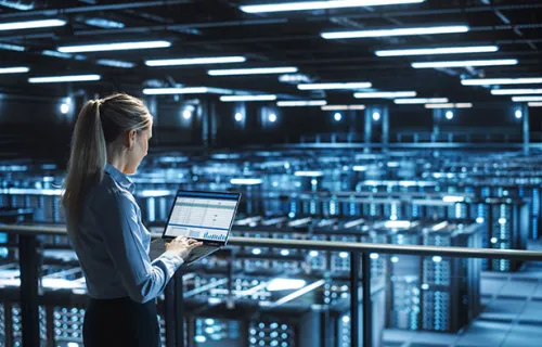 Data center IT specialist uses laptop computer