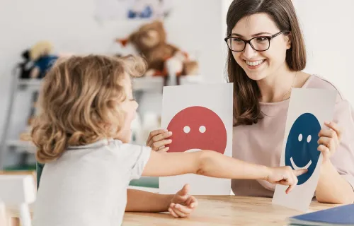 An adult and child working with drawings